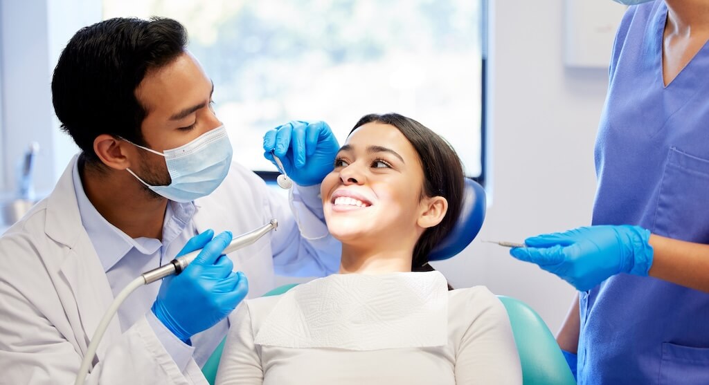A dentist examining a patient's teeth and bite