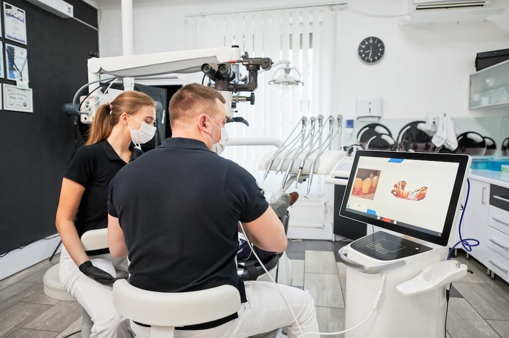 A dental team capturing a digital scan of a patient's smile