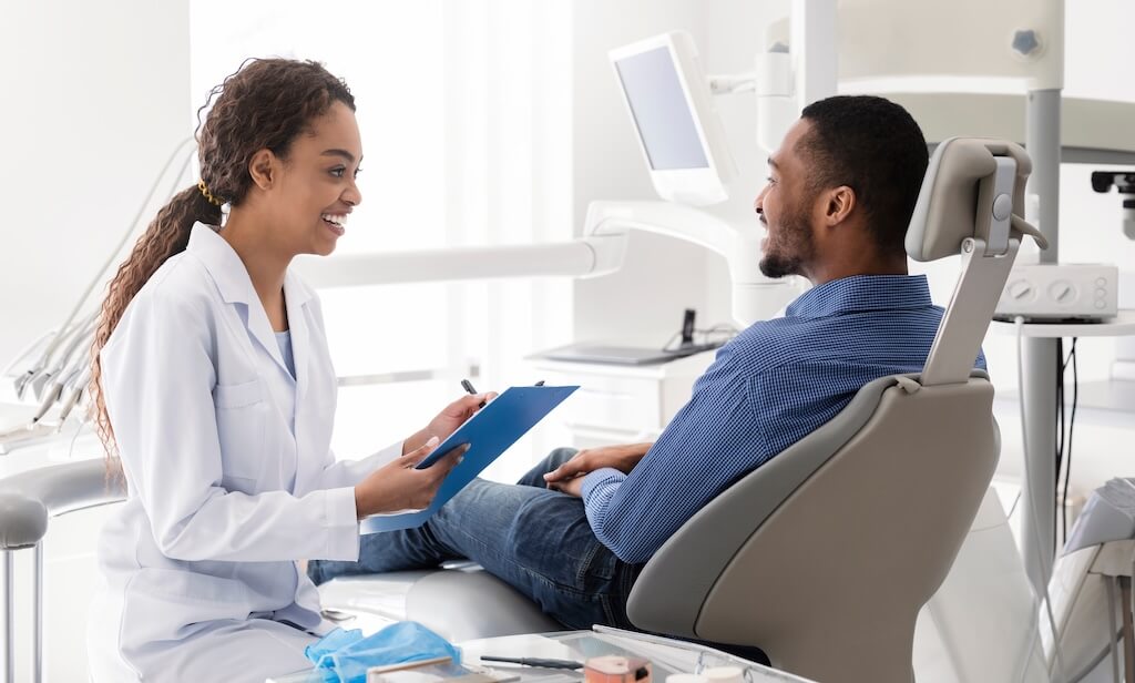 A dentist reviewing treatment timing and next steps with a patient