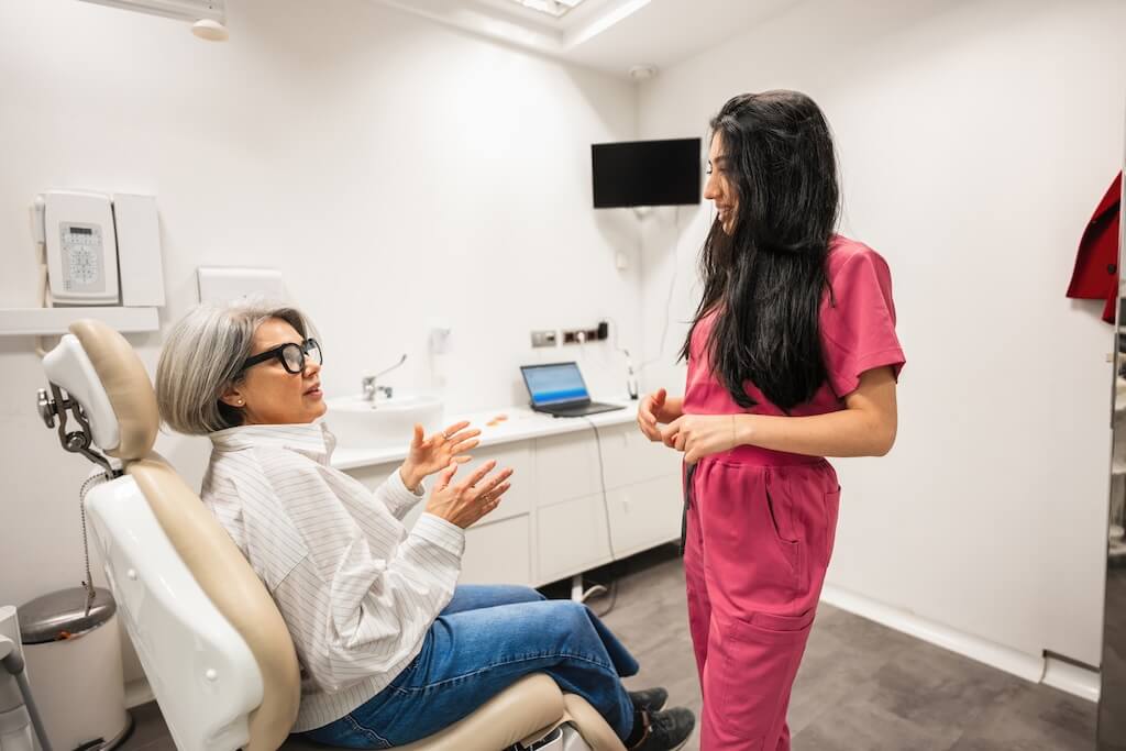 A dental professional discussing treatment goals with a patient