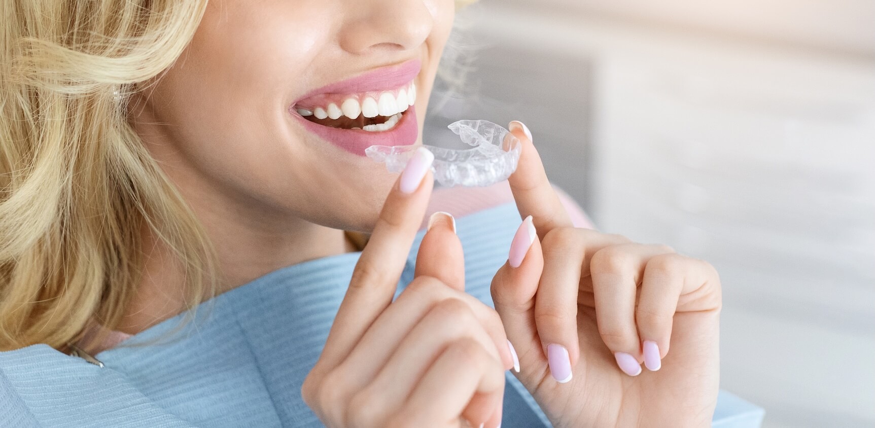 Person holding a clear invisalign aligner